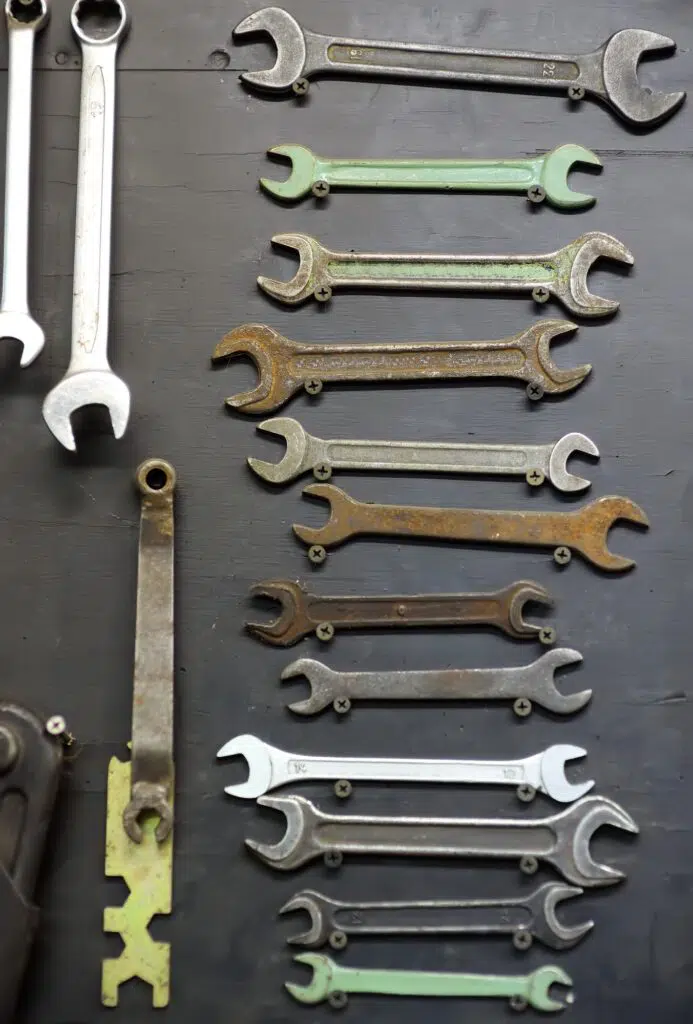 Set of spanners on a dark background. Many wrenches of different sizes. Work tools and equipments.